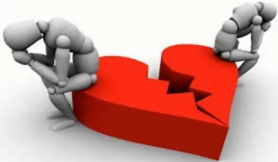 Two figures sitting beside a broken heart symbolizing relationship strain